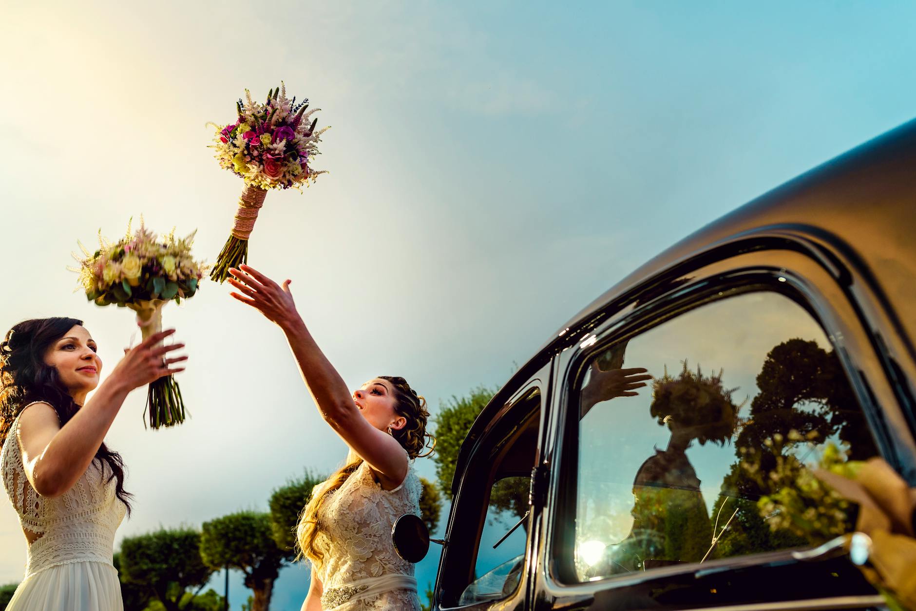 girl in white tank top holding purple flower bouquet